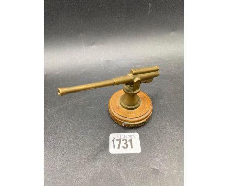 A brass anti aircraft gun on wood base 4.5" long