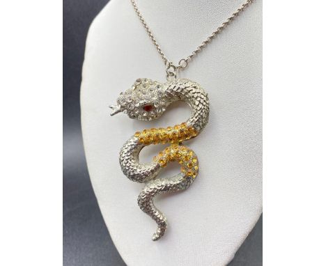 A large diamonte snake pendant on silver chain