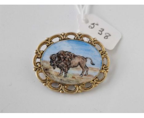 A silver gilt and enamel brooch of a Bison