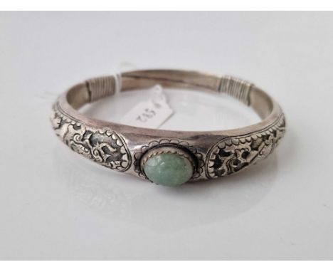 A Chinese silver bangle with jadeite stone