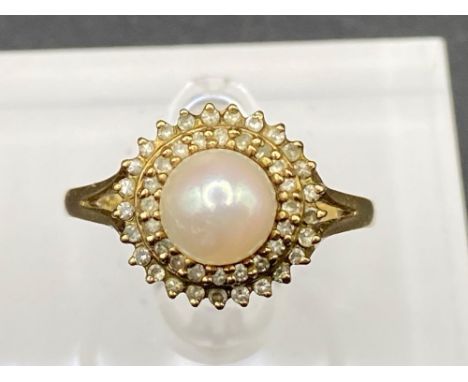 A vintage pearl and diamond ring the pearl surrounded by two circles of diamonds Size P