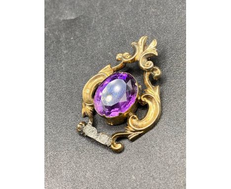 A early Victorian amethyst gold pendant of scrolled design AF