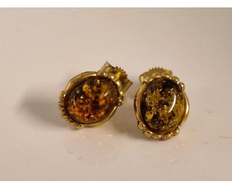 A pair of amber ear studs 9ct 1.9 gms