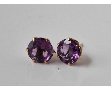 Pair of Amethyst gold stud earrings in coronet claw settings, the amethyst each measure approx 11mm in diameter