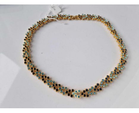 A gold tone multi stone necklace