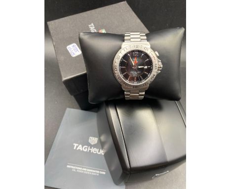 A TAG HEUER formula one gents wrist watch with date aperture and alarm in box with papers