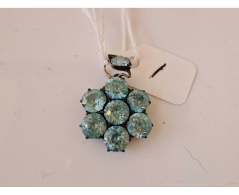 A attractive blue zircon eight stone flower pendant set in gold