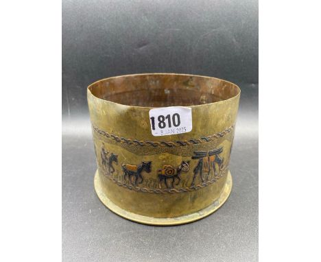 A heavy brass shell case dated 1916, the sides decorated enamel with camels etc, 6" diameter