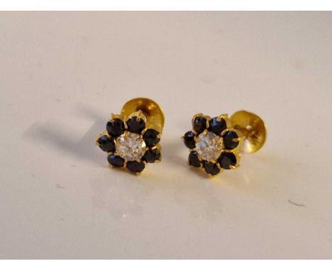 A pair of gold blue &amp; white stone shirt studs