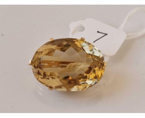 A large gold oval citrine brooch