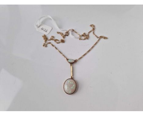 A opal drop pendant on neck chain set in gold 18 inch