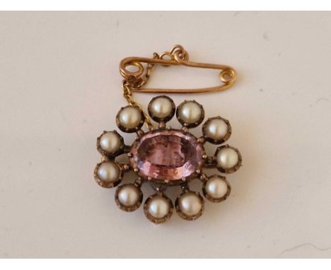 A Victorian amethyst and pearl brooch set in gold