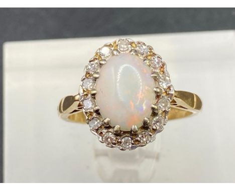 A opal and diamond cluster dress ring the opal with red and green good colours 9ct Size K