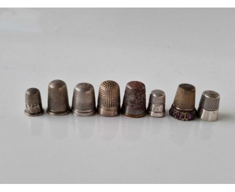 Eight various thimbles , some base metal