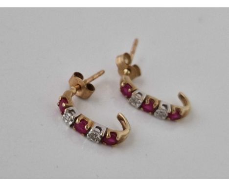 A pair of ruby and  diamond earrings matching 208 9ct