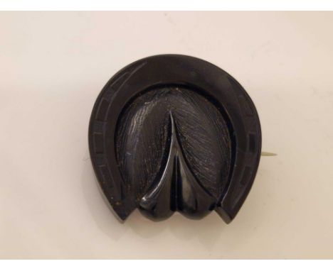 A jet horse shoe brooch