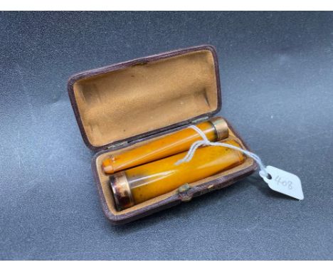 Two good amber gold mounted cheroot holders unoriginal case