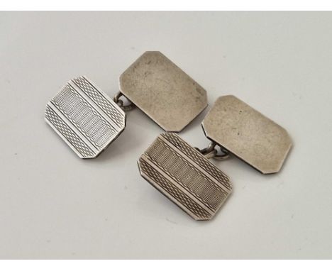 A pair of silver cufflinks