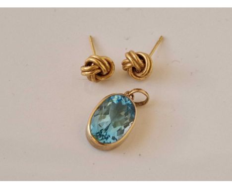 A blue topaz gold mounted pendant and pair of knot earrings 9ct