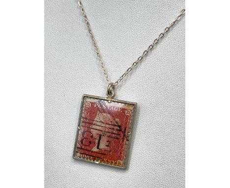 A silver one penny red stamp pendant on chain