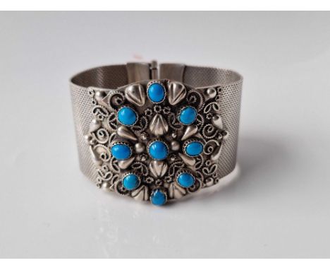 A silver and turquoise bracelet 97gms