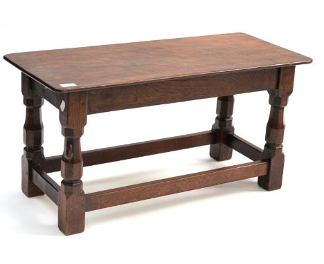 A Robert ''Mouseman'' Thompson Oak Double Dish Top Stool, the adzed top on four octagonal legs joined by stretchers, with car