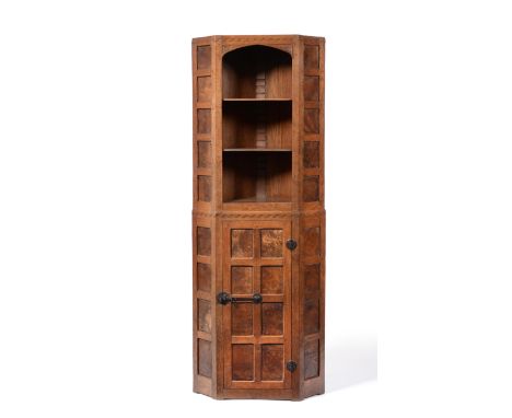 A 1930's Robert ''Mouseman'' Thompson Panelled Burr Oak Floor Standing Corner Cupboard, with open upper section, carved with 