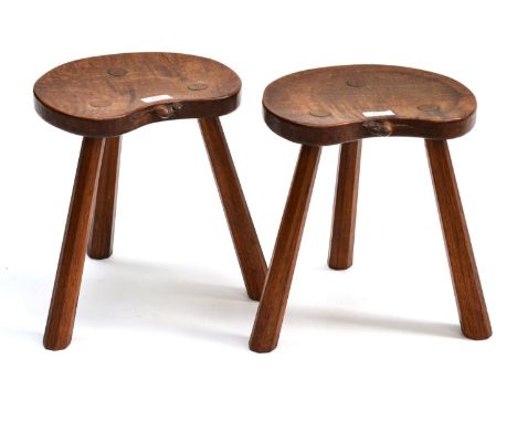 A Pair of Robert ''Mouseman'' Thompson Oak Calf Stools, the kidney shaped seats on three octagonal legs, each with carved mou