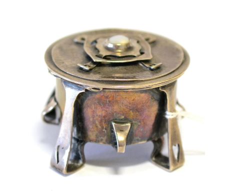 A William Hair Haseler Silver Ring Box, the hinged circular lid mounted with a mother-of-pearl cabochon, on four legs each wi