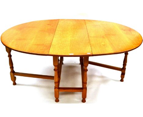An Albert ''Eagleman'' Jeffray Oak Gate Leg Table, the oval top on turned supports joined by stretchers, with recessed carved