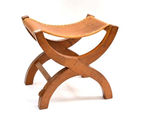 A Robert ''Mouseman'' Thompson Oak X Framed Stool, the slung hide seat supported by two X legs, joined by side rails, with ca