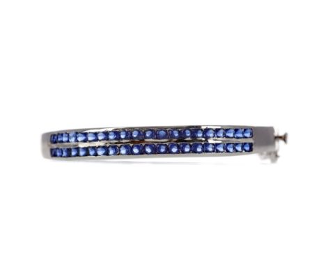 SAPPHIRE BANGLE, formed by two rows of round sapphires, 58mm diameter, unmarked, likely silver, 13.5g