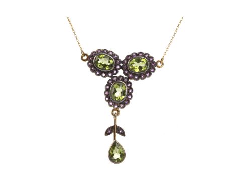 PERIDOT AND AMETHYST NECKLET, the three central oval peridots each within a halo of round amethysts, with pear shaped peridot