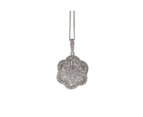 DIAMOND FLOWER PENDANT, with a central diamond cluster surrounded by tapered baguette cut diamonds, within a halo of round br