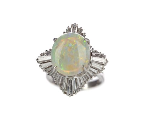 OPAL AND DIAMOND BALLERINA RING, set with an oval cabochon opal of approximately 4.48 carats, within a halo of tapered baguet