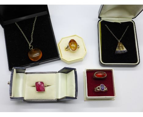 A silver and Blue John pendant and chain, a silver and amber ring, an amber pendant and three silver gem set rings 