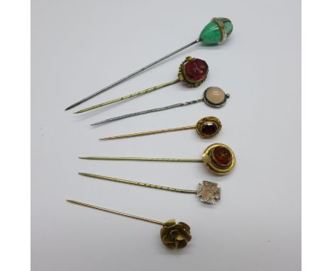 A collection of seven stick pins, including jade, garnet, etc. 