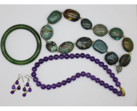 A turquoise bracelet, an amethyst necklace and earrings and a jade bangle 