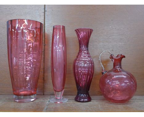 Four items of cranberry glass; large vase, 28cm, two other vases and a decanter, lacking stopper 