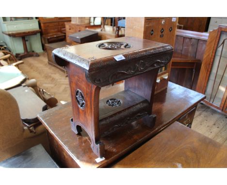 A late 19th Century carved mahogany stool with under shelf 