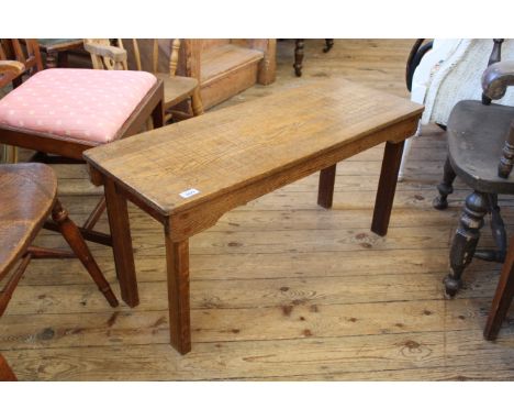 A 1920's oak bench, width 92cm x depth 35cm x height 45cm