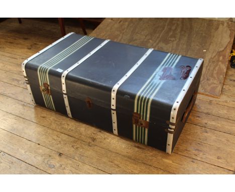 A metal banded and canvas vintage steamer trunk