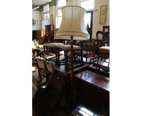 A mahogany standard lamp on circular base