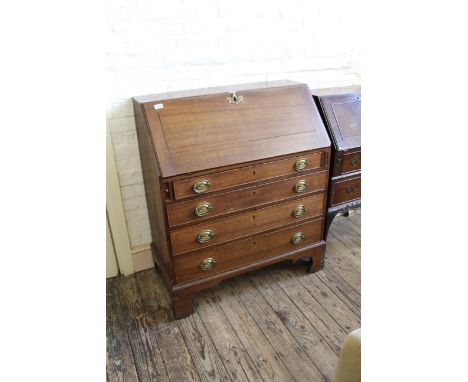 An early 19th Century oak four drawer bureau on bracket feet with fitted interior