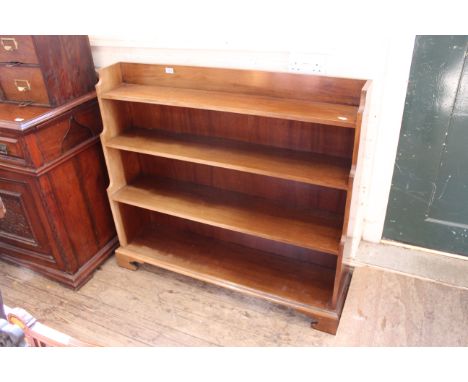 A 1920's mahogany waterfall bookcase on bracket feet