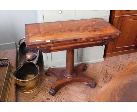 A William IV mahogany card table on platform base with rosewood cross banded top