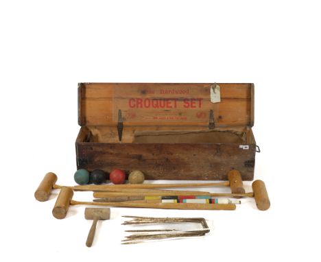 JOHN JAQUES: A CASED HARDWOOD CROQUET SETComprising four mallets, six hoops, central pole and four balls, pine box with vario