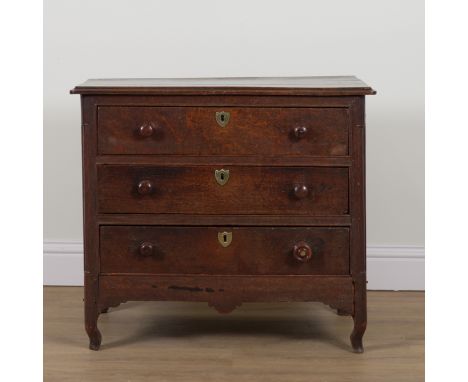 AN 18TH CENTURY CONTINENTAL OAK THREE DRAWER COMMODEOn squat scroll supports, 88cm wide; 47cm deep; 76cm high
