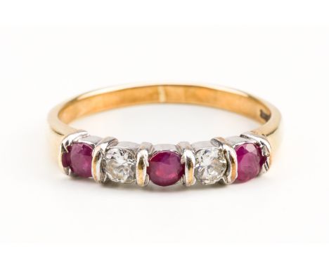 A 9CT GOLD RUBY AND DIAMOND FIVE STONE RINGMounted with three circular cut rubies, alternating with two round brilliant cut d