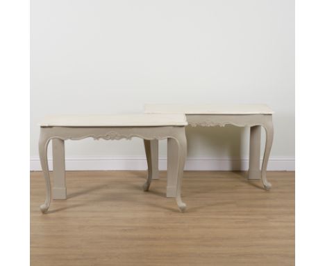 A PAIR OF 18TH CENTURY STYLE CREAM PAINTED CONSOLE TABLES (2)On scroll cabriole supports, 121cm wide; 49cm deep; 75cm high